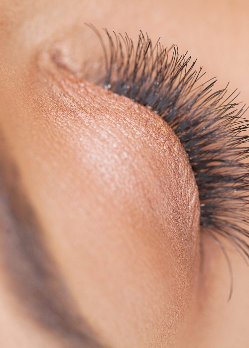 Eyelashes extensions. Fake Eyelashes. Eyelash Extension Procedure. Professional stylist lengthening female lashes. Master and a client in a beauty salon.